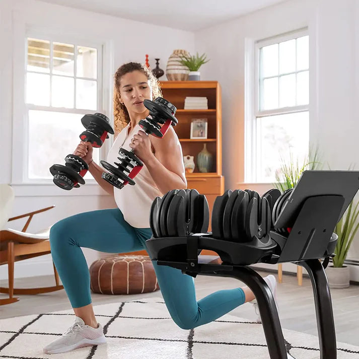Woman exercising with adjustable dumbbells in a home setting