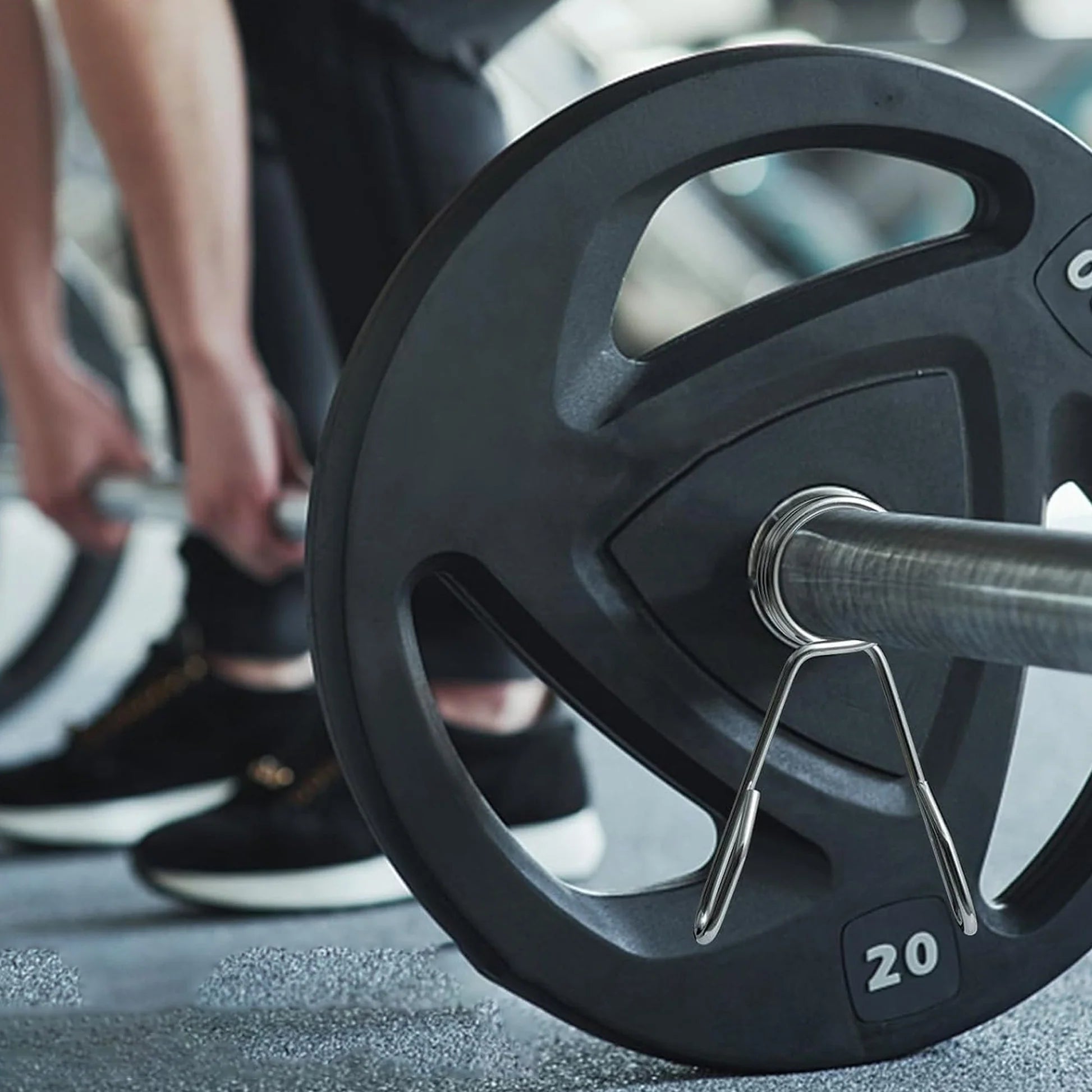 Close-up of a barbell with weight plates in a gym setting