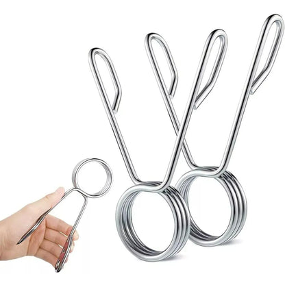 Metallic kitchen tongs on a white background