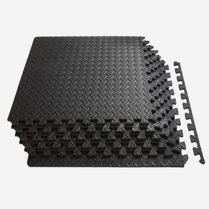 Stack of black interlocking foam mats on a white background