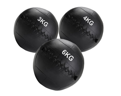 Three black weighted medicine balls with weight markings on a white background