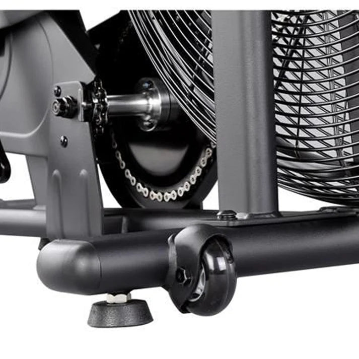 Close-up of a mechanical component with a fan and chain on a white background